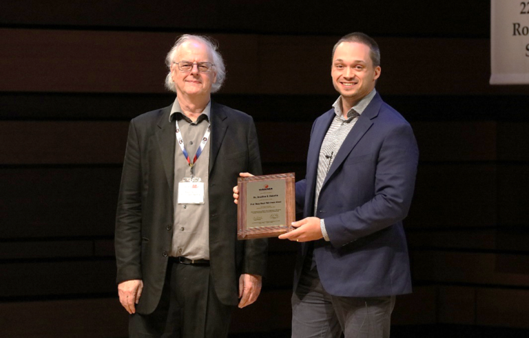 Jonathan Aubertin receives award from Doug Stead at RockEng22 Symposium, August 9, 2022